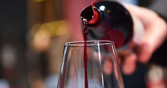 Pouring red wine in Tuscany